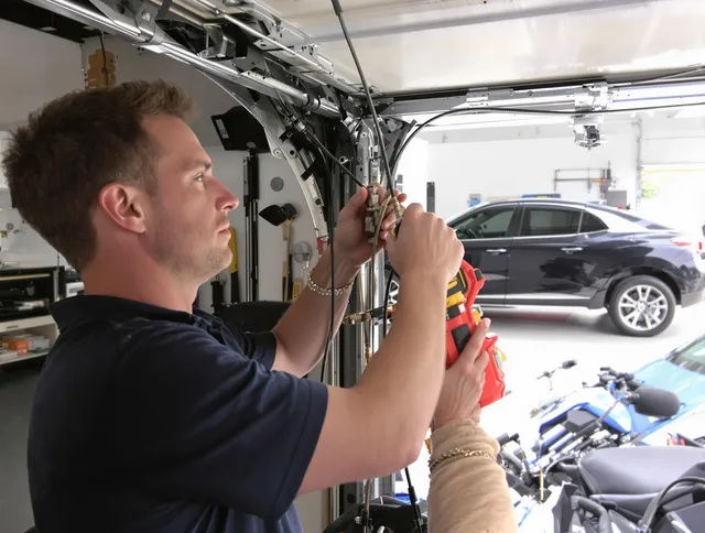 Wallingford Garage Door Repair safety certified technician performing cable replacement in Wallingford